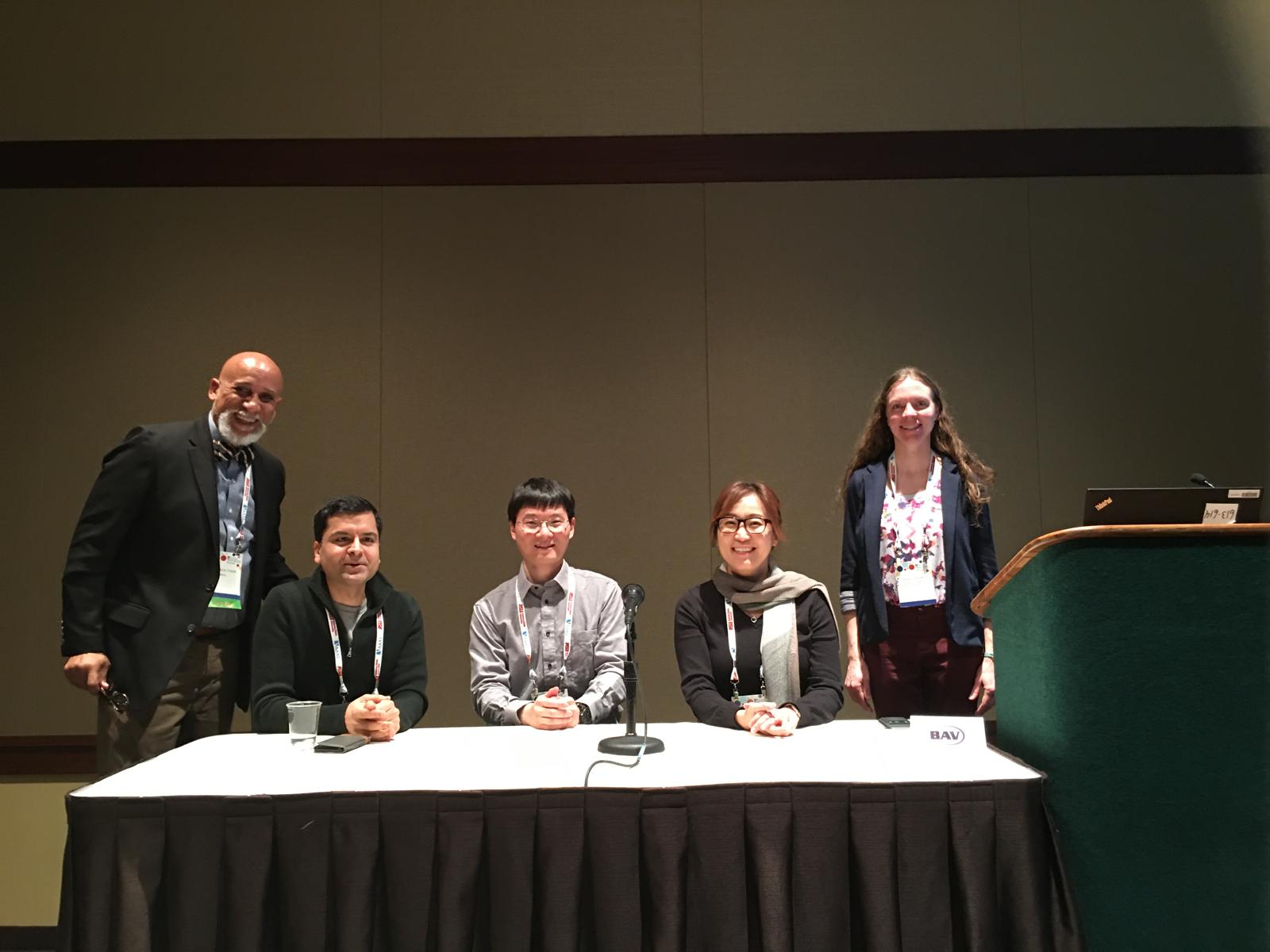 Dr. Frederick Tyson with co-chairs and speakers at a conference session
