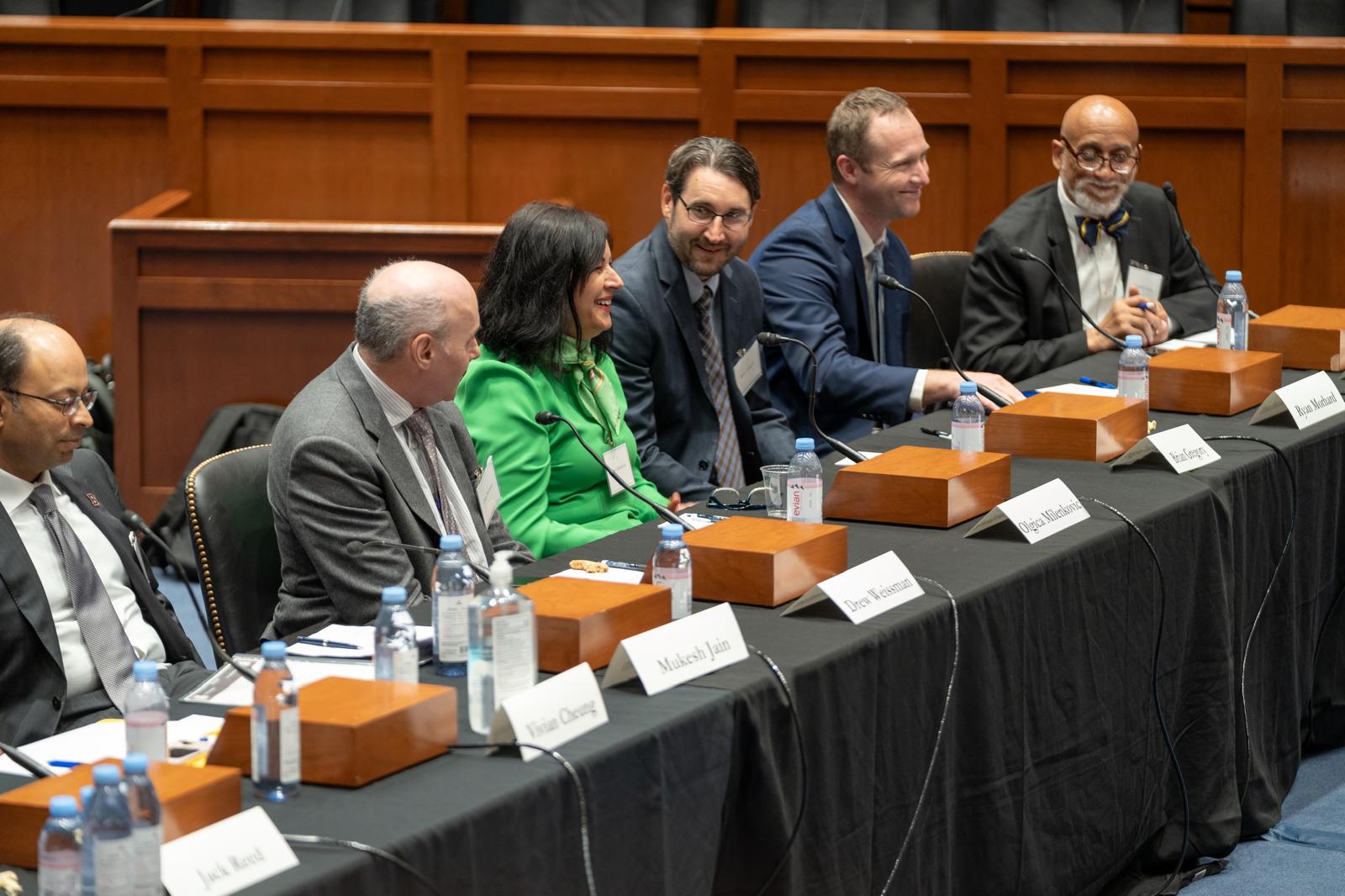Dr. Frederick Tyson seated with fellow panelists at a formal hearing table