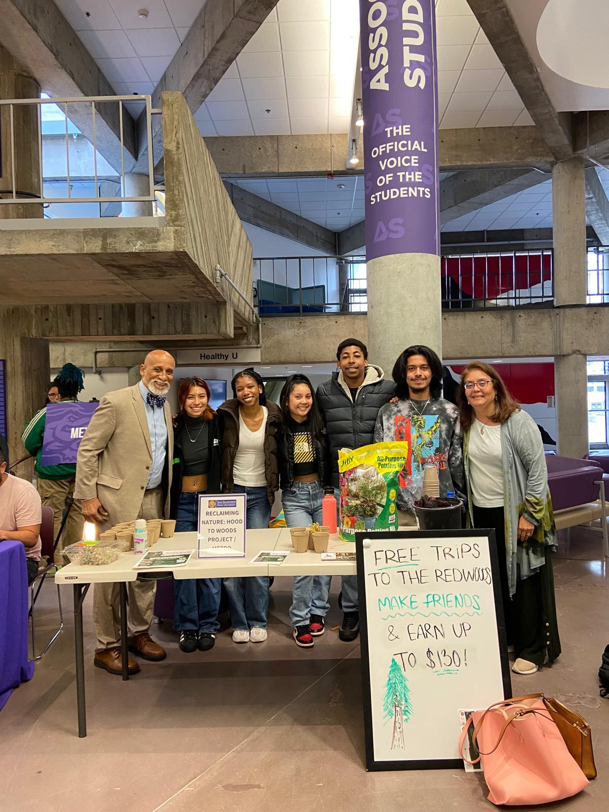 Dr. Frederick Tyson with student researchers at a campus outreach table